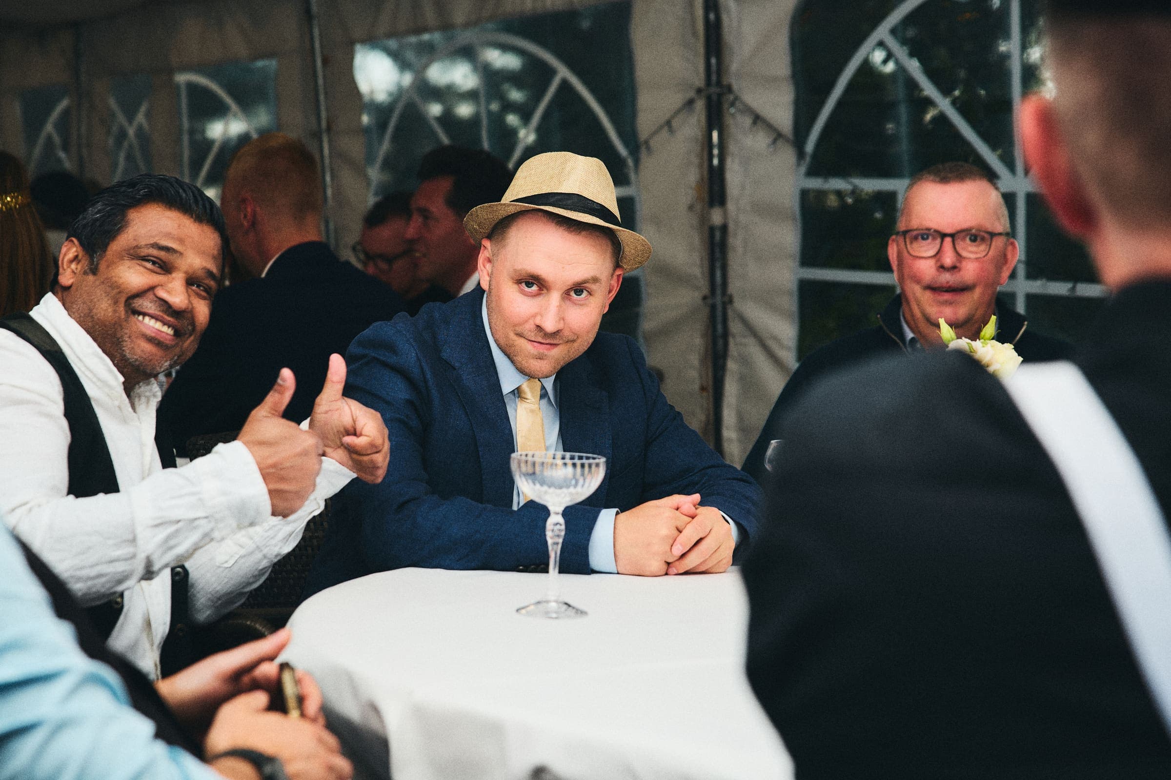 Smilende gjester rundt et bord under arrangementet